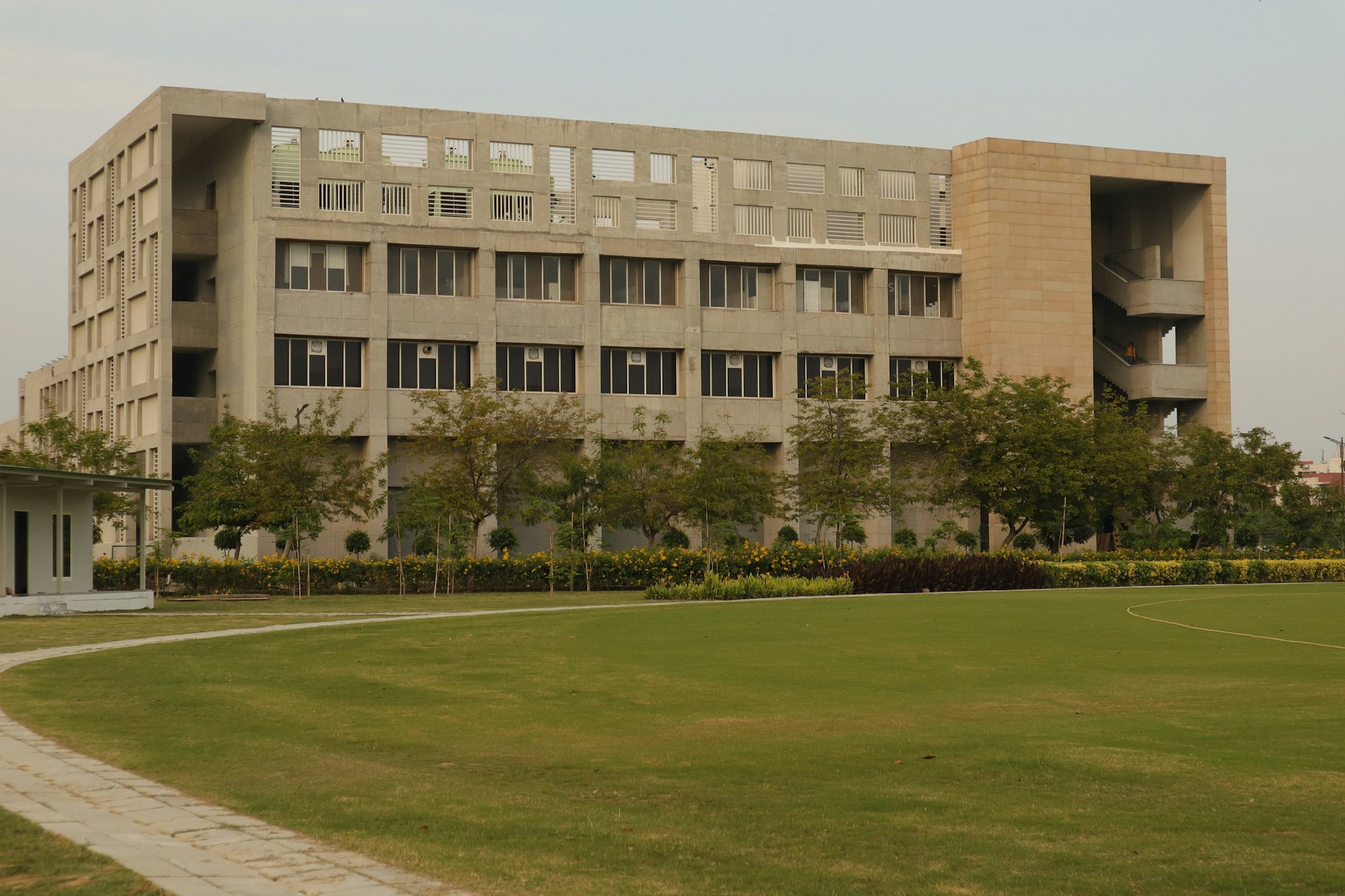 a large building sitting on top of a lush green field